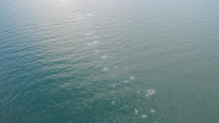 A seasonal oil sheen on Aug. 29, 2022, near Destin, Florida. Coast Guard and Florida Department of Environmental Protection have been monitoring periodic oil discharge from Liberty Ship Thomas Heyward. (U.S. Coast Guard photo by Petty Officer 2nd Class Joshua Ronkowski)