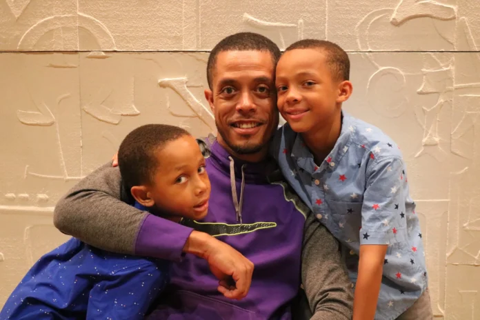 Jeffrey Daniels embraces his two sons as he reflects on what Father's Day means to him. Credit: Nigell Moses/Verite News