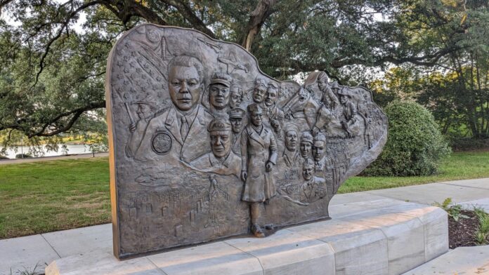 Gov. John Bel Edwards unveiled a sculpture to honor Black military members at Veterans Memorial Park near the State Capitol in Baton Rouge. (Julie O’Donoghue/Louiaiana Illuminator)